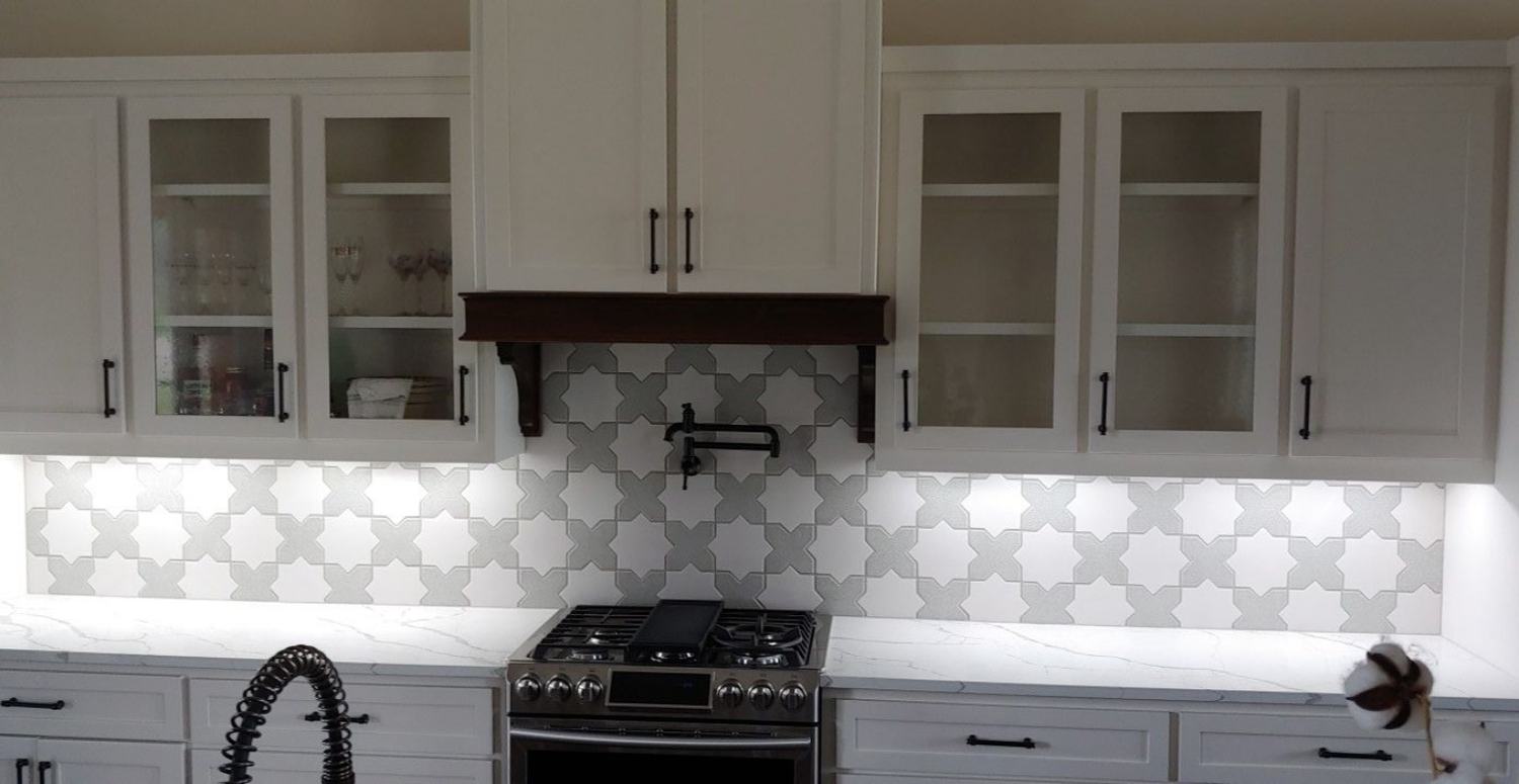 Completed kitchen cabinet and patterned tile backsplash detail.