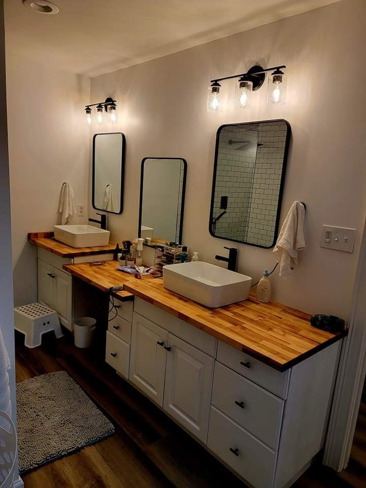 Bathroom vanity with vessel sink and wood countertop by MMAC Renovation