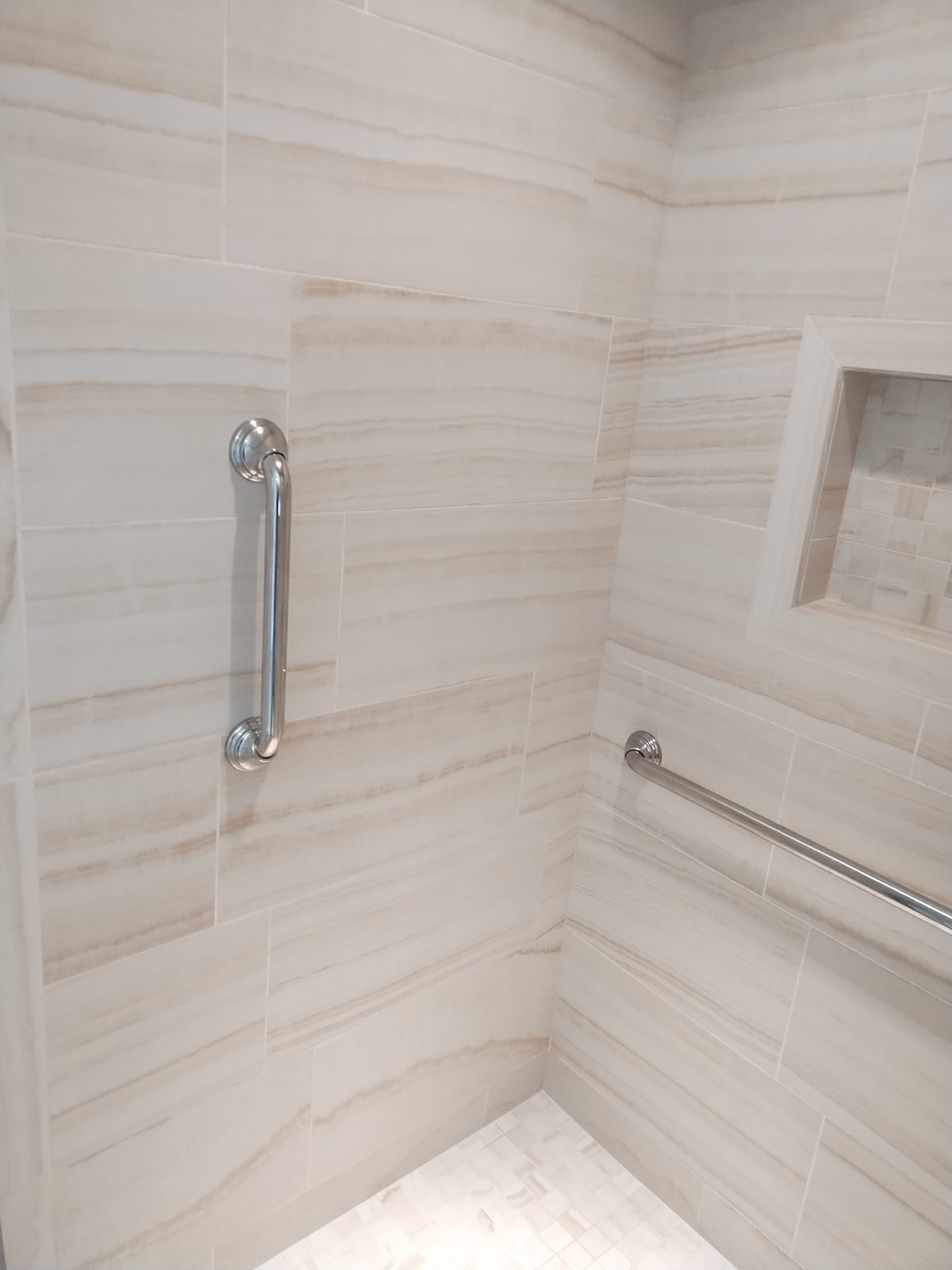 Marble-look tiled shower with glass enclosure — Dublin GA bathroom remodel