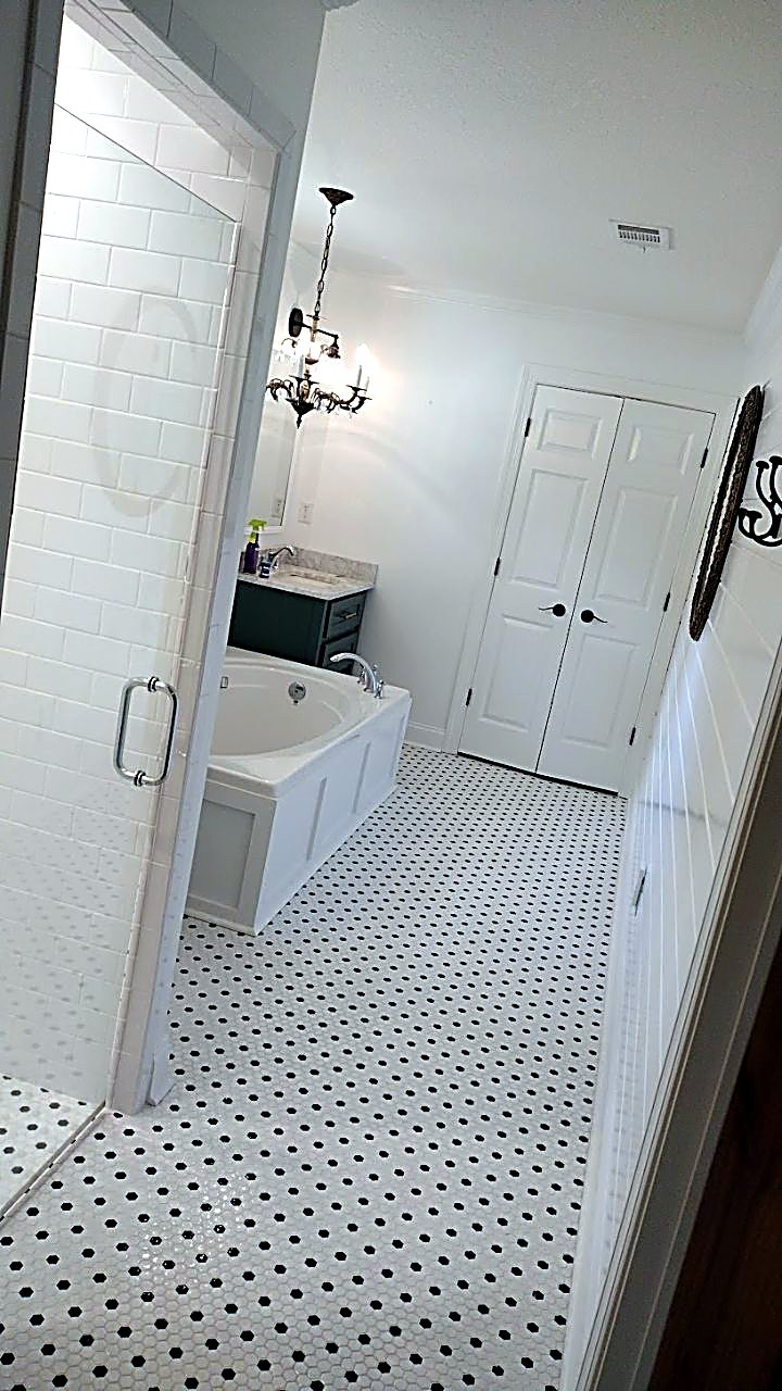 Finished bathroom with penny-tile floor, vanity and tub by MMAC Renovation, Laurens County GA