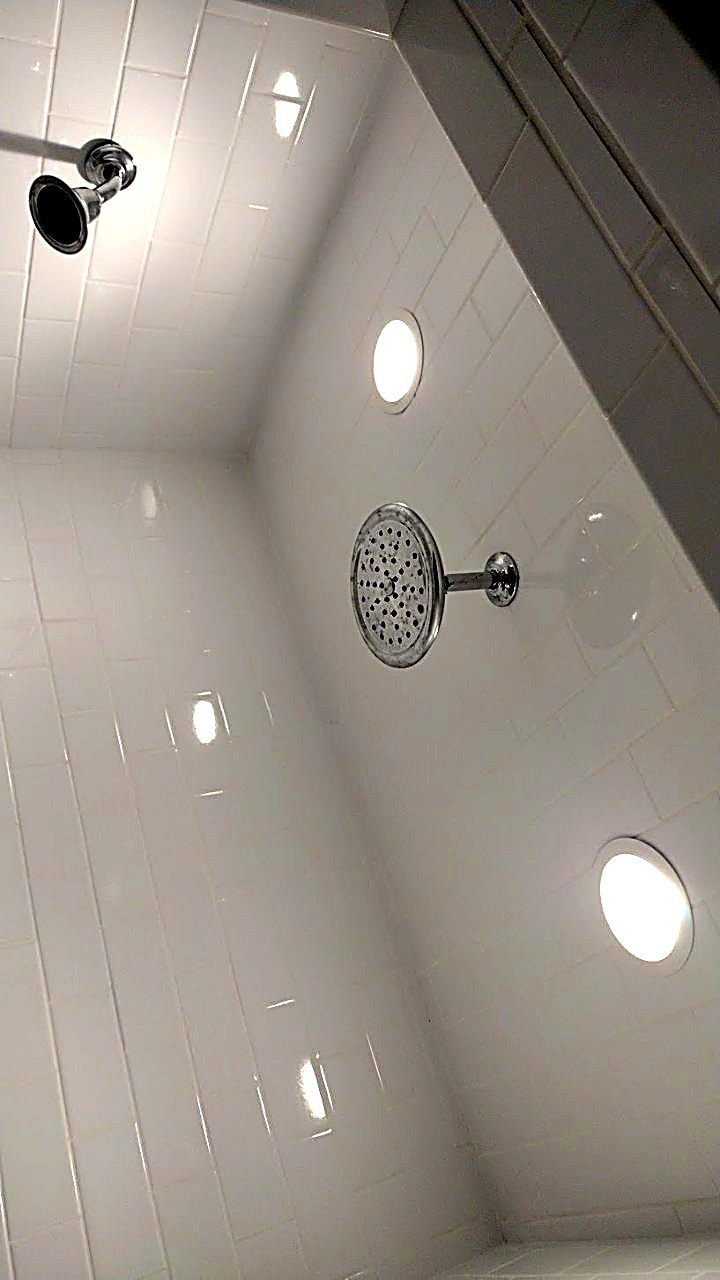 White tiled shower with niche and fixtures — Laurens County bathroom
