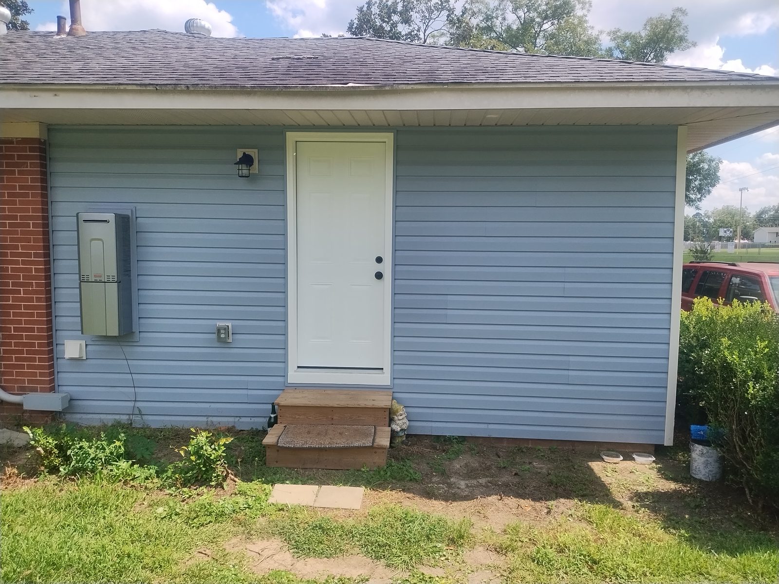 Home with new blue siding, entry door and steps — exterior remodel, Laurens County GA