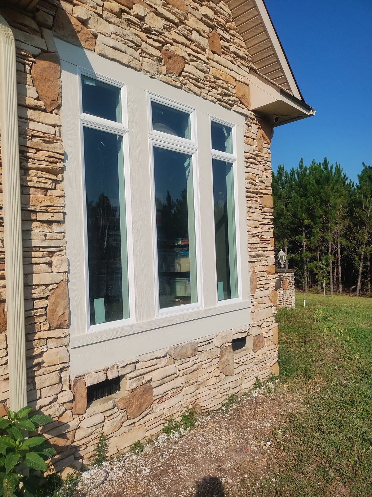 Brick home with newly installed bay and casement windows by MMAC Renovation