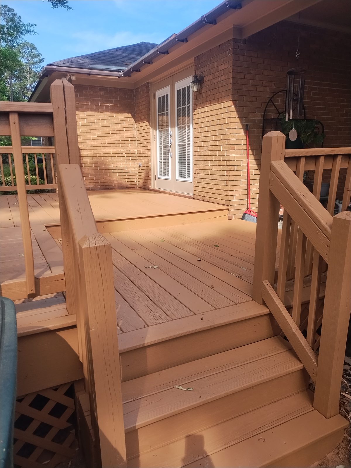 New pressure-treated wood deck with stairs and railing by MMAC Renovation