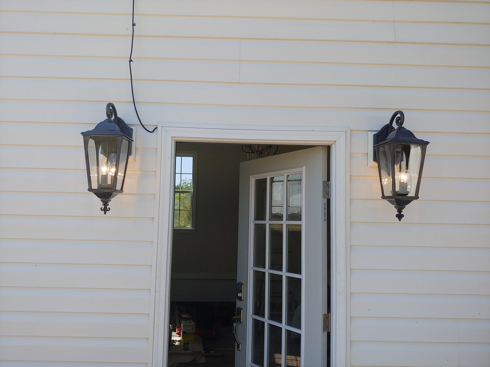 Double entry doors with carriage-style light fixtures — exterior carpentry