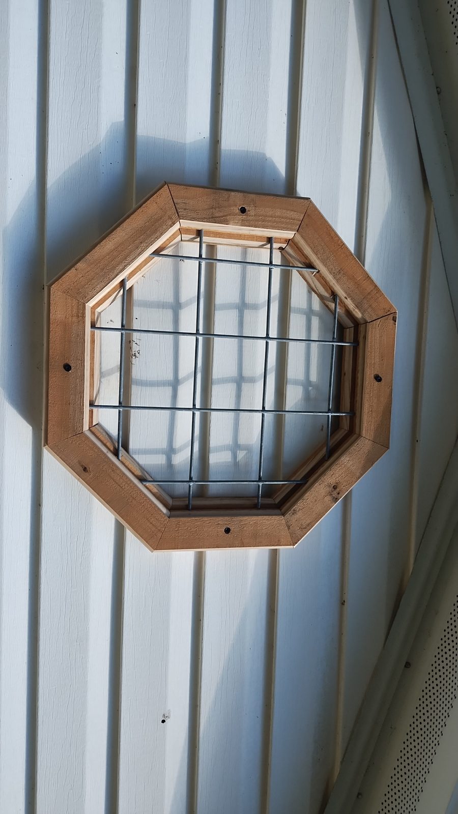 Custom octagon accent window with wood trim — MMAC Renovation