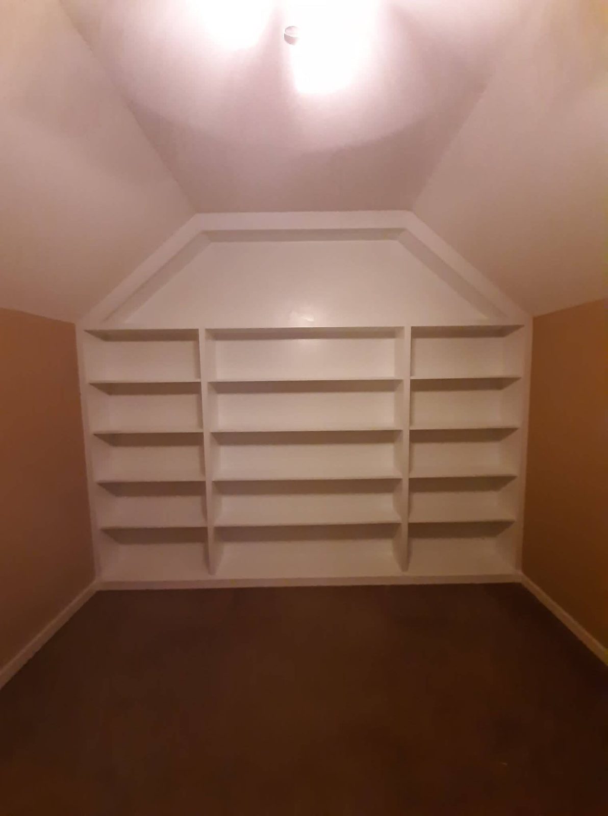 White built-in shelving under a vaulted ceiling — MMAC Renovation built-ins