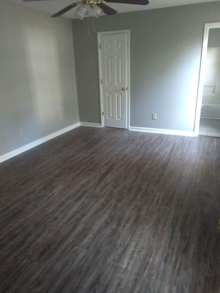 Remodeled room with new dark luxury-vinyl-plank flooring and trim
