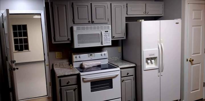 Gray kitchen cabinets with white appliances and tile floor — Laurens County kitchen remodel