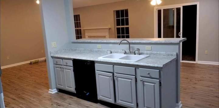 Gray kitchen island with marble-look counter and undermount sink — Dublin GA remodel